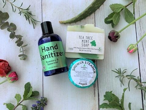 The Take Care Kit features Hand Sanitizer, Natural Soap and a Shower Steamer. Rosemary & Spearmint, Tea Tree Mint, and Awake